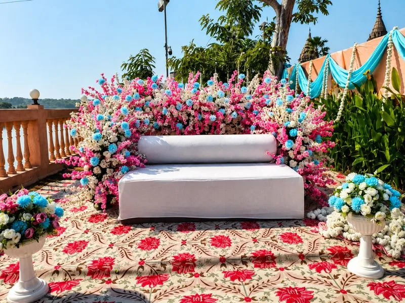 Outdoor floral wedding sofa stage decor by DFD Wedding Events